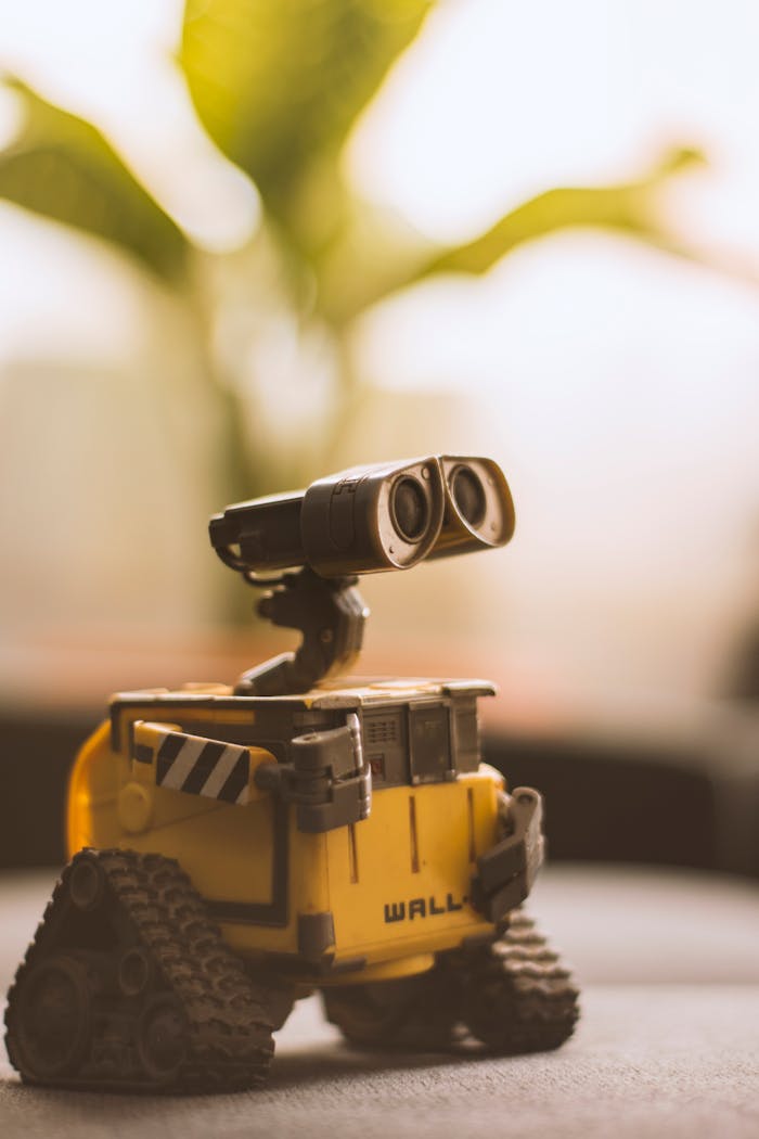 our-story Charming toy robot placed on a desk, perfect for tech and nostalgia themes.